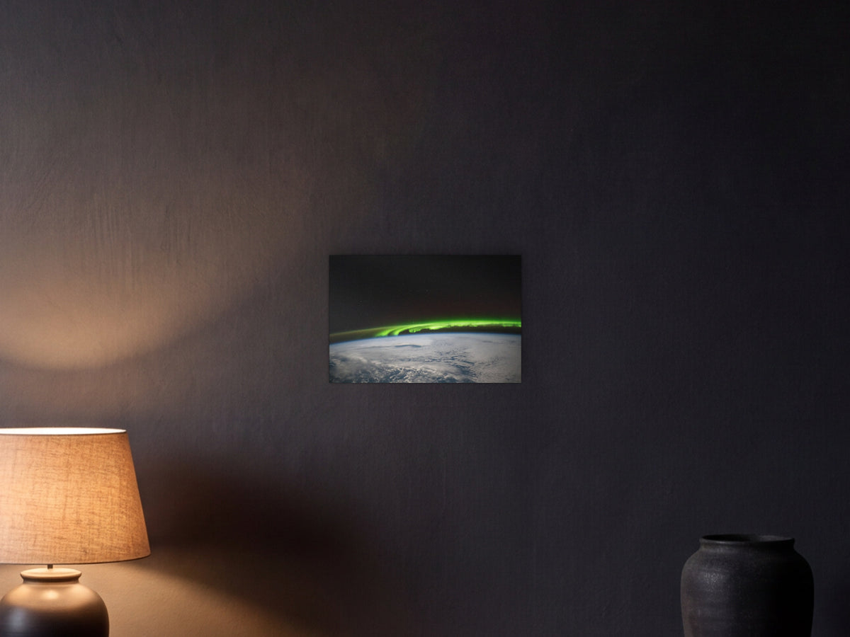Aurora over the North Pacific shown in a graphite plaster wall at night, lit by a console lamp - scale render at 45 × 30 cm