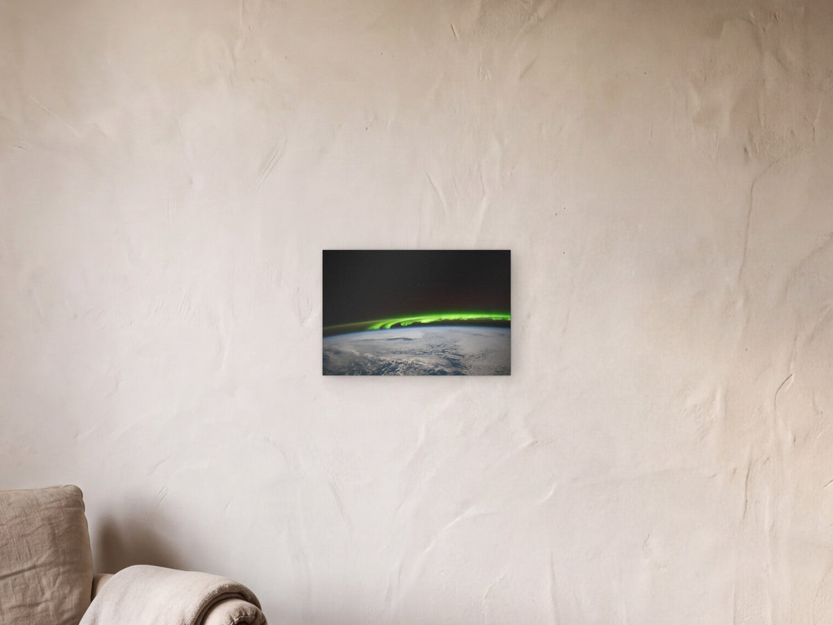 Aurora over the North Pacific shown in a limewash reading corner beside an armchair and a floor lamp - scale render at 45 × 30 cm