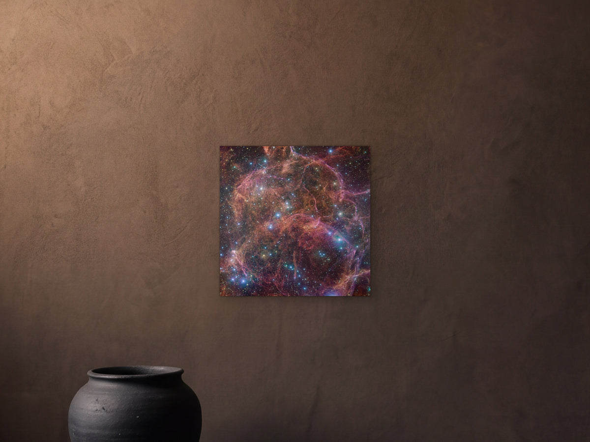 Vela supernova remnant - Metal Print 40 × 40 cm shown in a dark room with an umber plaster wall and a stone plinth - scale render at 40 × 40 cm